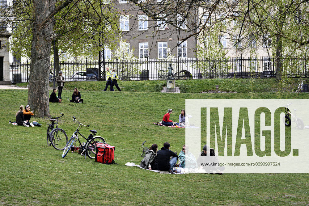 Police patrol while the Copenhageners enjoy the spring sun in the Orestedsparken in Copenhagen on Sunday, April 26, 2020 There are assembly bans of more than ten people due to the danger of infection with coronavirus covid 19 NOTE one it really is , Copenhagen Denmark,