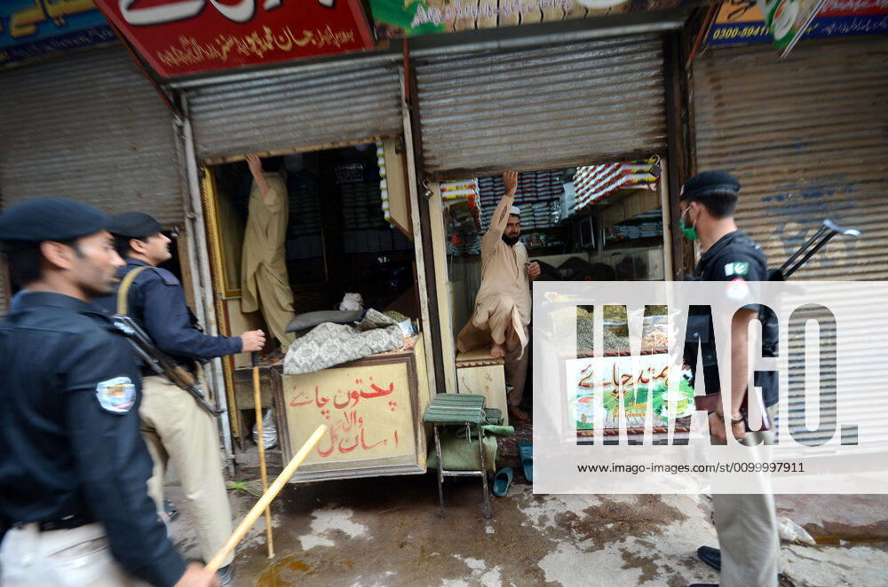 Pakistan: Police officials closing shops Police officials closing shops in the city for precautionary measures to prevent corona virus. Authorities appealed for people to avoid public gatherings to curb the spread of the corona virus and close shops until four o clock in the month of Ramadan. Peshawar Khyber Pakhtunkhwa Pakistan