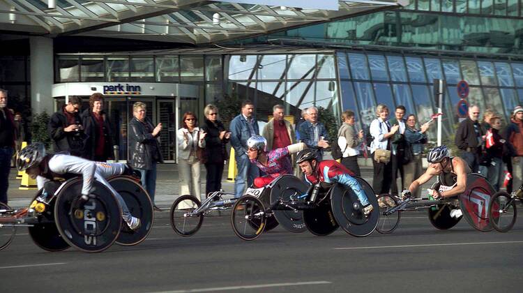 Rollstuhlfahrer bekommen bei der Durchfahrt Beifall von den Zuschauern Behindertensport 30. Internationaler Berlin-Marathon 2003, Stadtmarathon, Citymarathon, Marathonlauf, Langstrecke Totale Berlin Dynamik,
