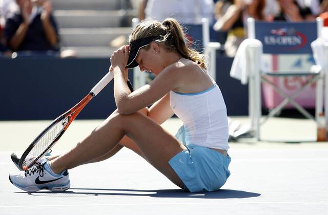 Olivia Rogowska falls to the ground after losing a point in the third set of her first round match at the US Open  NYP20090901127