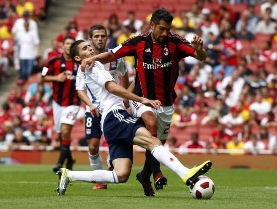 Football - Emirates Cup - AC Milan v Olympique Lyonnais Maxime Gonalons of Lyon (L) tackles Marco Borriello of AC Milan at Emirates Stadium