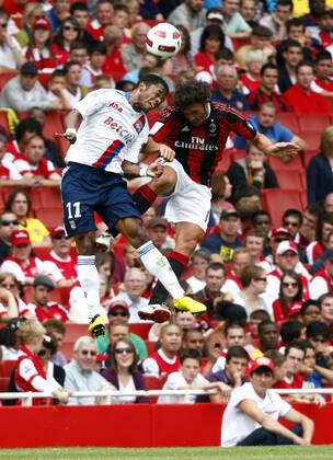 Football - Emirates Cup - AC Milan v Olympique Lyonnais Michel Bastos (L) of Lyon beats Massimo Oddo of AC Milan at Emirates Stadium