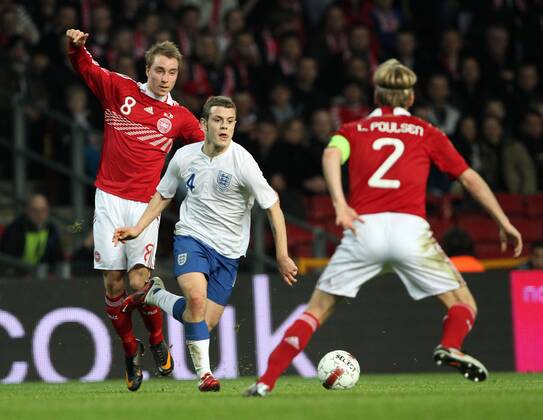 Denmarks Christian Eriksen (L) tussles with Englands Jack Wilshere International Friendly Denmark v England 9th February, 2011 EDITORIAL USE ONLY. No use with unauthorised audio, video, data, fixture lists, club league logos or live services. Online in-match use limited to 120 images, no video emulation. No use in betting, games or single club league player publications.