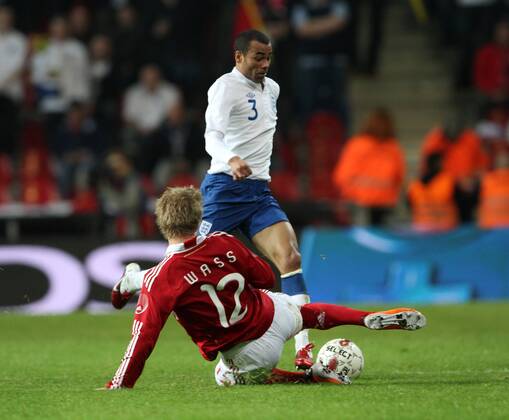 Denmarks Daniel Wass (L) tussles with Englands Ashley Cole International Friendly Denmark v England 9th February, 2011 EDITORIAL USE ONLY. No use with unauthorised audio, video, data, fixture lists, club league logos or live services. Online in-match use limited to 120 images, no video emulation. No use in betting, games or single club league player publications.