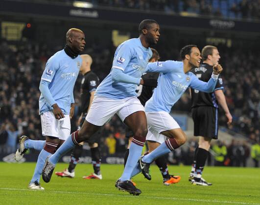 Football - FA Cup Fifth Round - Manchester City vs. Aston Villa -- Yaya Toure of Manchester City celeebrates his opening goal with team mates Mario Balotelli (L) and Jolean Lescott (R) at the City of Manchester Stadium EDITORIAL USE ONLY. No use with unauthorised audio, video, data, fixture lists, club league logos or live services. Online in-match use limited to 120 images, no video emulation. No use in betting, games or single club league player publications.