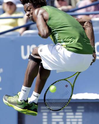 Gael Monfils of France leaps and hits a ball behind him in his match on day 4 in Louis Armstrong Stadium at the U.S. Open Tennis Championships Stadium at the Billie Jean King National Tennis Center in New York City on September 1, 2011.  NYP20110901111