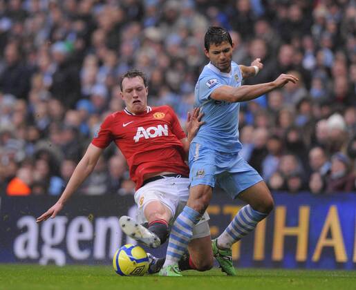 Phil Jones of Manchester United tussles with Sergio Kun Aguero of Manchester City The FA Cup with Budweiser 3rd Round Manchester City v Manchester Utd at the Etihad Stadium, Manchester. 8th January, 2012 EDITORIAL USE ONLY. No use with unauthorised audio, video, data, fixture lists, club league logos or live services. Online in-match use limited to 120 images, no video emulation. No use in betting, games or single club league player publications.