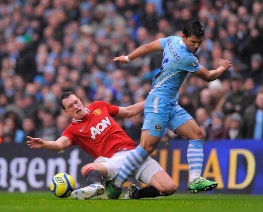 Phil Jones of Manchester United tussles with Sergio Kun Aguero of Manchester City The FA Cup with Budweiser 3rd Round Manchester City v Manchester Utd at the Etihad Stadium, Manchester. 8th January, 2012 EDITORIAL USE ONLY. No use with unauthorised audio, video, data, fixture lists, club league logos or live services. Online in-match use limited to 120 images, no video emulation. No use in betting, games or single club league player publications.