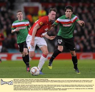Phil Jones of Manchester United tussles with Javi Martinez of Athletic Bilbao..UEFA Europa League round of 16 match between Manchester Utd v Athletic Bilbao at Old Trafford Stadium, Manchester on the 8th March EDITORIAL USE ONLY. No use with unauthorised audio, video, data, fixture lists, club league logos or live services. Online in-match use limited to 120 images, no video emulation. No use in betting, games or single club league player publications.