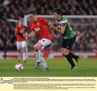 Phil Jones of Manchester United tussles with Javi Martinez of Athletic Bilbao..UEFA Europa League round of 16 match between Manchester Utd v Athletic Bilbao at Old Trafford Stadium, Manchester on the 8th March EDITORIAL USE ONLY. No use with unauthorised audio, video, data, fixture lists, club league logos or live services. Online in-match use limited to 120 images, no video emulation. No use in betting, games or single club league player publications.