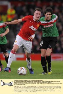 Phil Jones of Manchester United tussles with Javi Martinez of Athletic Bilbao..UEFA Europa League round of 16 match between Manchester Utd v Athletic Bilbao at Old Trafford Stadium, Manchester on the 8th March EDITORIAL USE ONLY. No use with unauthorised audio, video, data, fixture lists, club league logos or live services. Online in-match use limited to 120 images, no video emulation. No use in betting, games or single club league player publications.