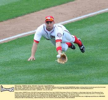 April 15, 2012 - Washington, District of Columbia, U.S. - Washington Nationals third baseman RYAN ZIMMERMAN makes a diving catch on a bunt pop up by the Cincinnati Reds Wilson Valdez in the 11th inning at Nationals Park. The Reds won 8-5 in 11 innings. MLB Baseball Herren USA 2012 - Reds Beat Nationals 8-5 - ZUMAm67