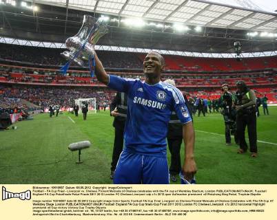 Football - FA Cup Final - Liverpool vs. Chelsea. Florent Malouda of Chelsea celebrates with the FA cup at Wembley Stadium, London