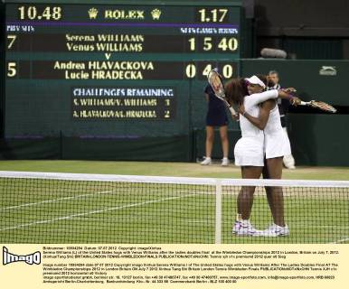 Serena Williams (L) of the United States hugs with Venus Williams after the ladies doubles final at the Wimbledon Championships 2012 in London, Britain on July 7, 2012. (Xinhua Tang Shi) BRITAIN-LONDON-TENNIS-WIMBLEDON-FINALS 