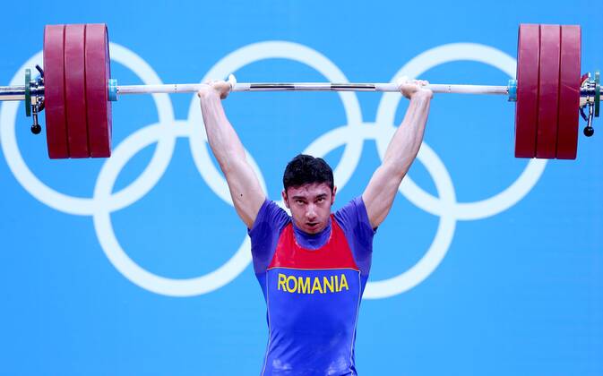 (120731) -- LONDON, July 31, 2012 (Xinhua) -- Razvan Constantin Martin of Romania competes during men s weightlifting 69kg competition at London 2012 Olympic Games in London, Britain, July 31, 2012. Razvan Constantin won bronze medal in this event. (Xinhua Chen Jianli) (zgp) (OLY2012)BRITAIN-LONDON-WEIGHTLIFTING-MEN S 69KG 