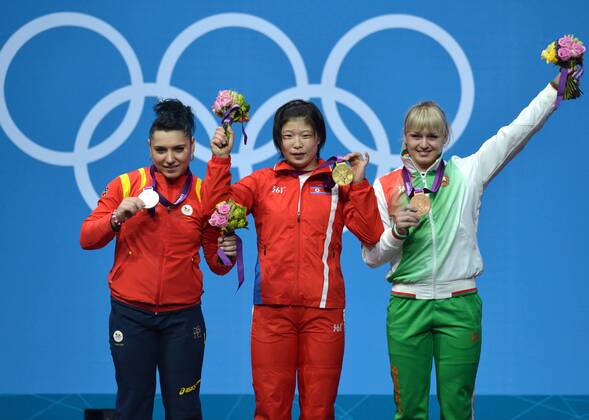 LONDON, Aug. 1, 2012 -- goldmedalist Rim Jong Sim of the Democratic People s Republic of Korea (C), silve medalist Roxana Daniela Cocos of Romania (L), and Bronzemedalist Maryna Shkermankova of Belarus celebrate at the awarding ceremony of women s 69kg weightlifting event at London 2012 Olympic Games, London, Britain, Aug. 1, 2012. (Xinhua Gong Lei) (OLY2012)BRITAIN-LONDON-WEIGHTLIFTING-WOMEN-69KG 
