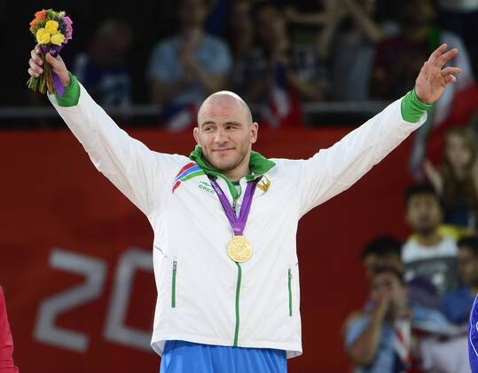 Artur Taymazov of Uzbekistan acknowledges the cheers of the crowd after receiving the Gold Medal for his victory over over Davit Modzmanashvili of Georgia in the Men s 120kg Freestyle Wrestling at the London 2012 Summer Olympics on August 10, 2012 in London.  OLY20120811305