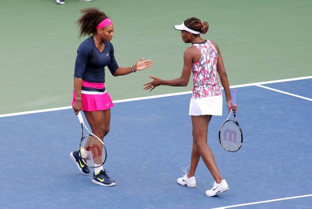 Serena Williams (L) and her sister Venus, USA, congratulate each other during the first-round women s double match at the 2012 U.S. Open held at the National Tennis Center on August 29, 2012 in New York. UPI Photo Monika Graff  NYP20120829339