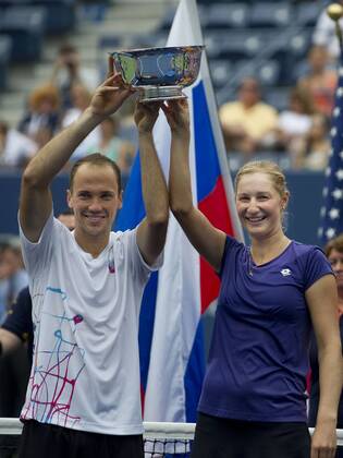 September 06, 2012: Ekaterina Makarova of Russia, and Bruno Soares of Brazil pose with trophies to become the 2012 US Open Mixed Doubles Champions. during the US Open tennis tournament at the BillieJeanKing National Tennis Center in Flushing, NY. TENNIS: SEP 06 US Open Icon20143367 EDITORIAL USE ONLY