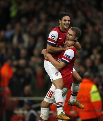 Arsenal s Aaron Ramsey celebrates scoring his sides third goal..Football - Champions League Matchday 2 - Emirates Stadium, London - 3 10 12EDITORIAL USE ONLY. EDITORIAL USE ONLY. No use with unauthorised audio, video, data, fixture lists, club league logos or live services. Online in-match use limited to 120 images, no video emulation. No use in betting, games or single club league player publications.