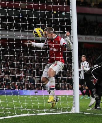 Arsenal s Lukas Podolski scoring his sides third goal..- Arsenal v Newcastle United - Barclays Premier League - the Emirates Stadium, London- 29 12 12 - Picture David Klein Sportimage EDITORIAL USE ONLY. No use with unauthorised audio, video, data, fixture lists, club league logos or live services. Online in-match use limited to 120 images, no video emulation. No use in betting, games or single club league player publications.