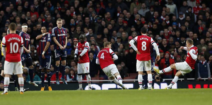 Arsenal s Lukas Podolski scoring his sides opening goal..Arsenal v Stoke - Barclays Premier League - Emirates Stadium, London- 02 02 13 - Picture David Klein Sportimage EDITORIAL USE ONLY. No use with unauthorised audio, video, data, fixture lists, club league logos or live services. Online in-match use limited to 120 images, no video emulation. No use in betting, games or single club league player publications.