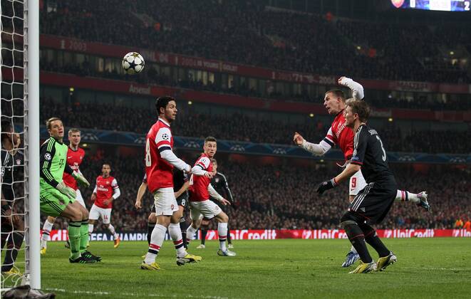 Arsenal s Lukas Podolski scoring his sides opening goal..Arsenal v Bayern Munich - Champions League Second Round, First Leg- Emirates Stadium, London- 19 02 13 - Picture David Klein Sportimage EDITORIAL USE ONLY. No use with unauthorised audio, video, data, fixture lists, club league logos or live services. Online in-match use limited to 120 images, no video emulation. No use in betting, games or single club league player publications.