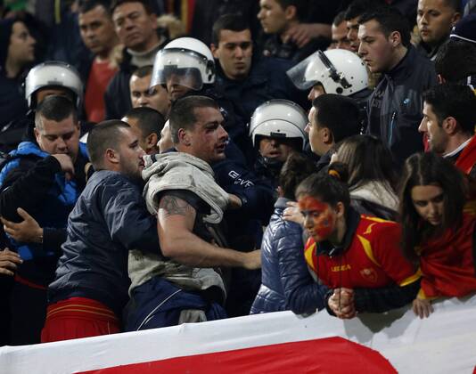 Montenegro s fans fight amongst themselves before kick-off..Montenegro - World Cup Qualifier - Podgorica City Stadium, Podgorica- 26 03 13 - DavidxKlein Sportimage EDITORIAL USE ONLY. No use with unauthorised audio, video, data, fixture lists, club league logos or live services. Online in-match use limited to 120 images, no video emulation. No use in betting, games or single club league player publications.