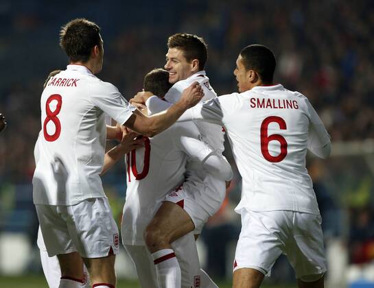 England s Steven Gerrard celebrates with goalscorer Wayne Rooney..Montenegro v England- World Cup Qualifier - Podgorica City Stadium, Podgorica- 26 03 13 - Picture David Klein Sportimage EDITORIAL USE ONLY. No use with unauthorised audio, video, data, fixture lists, club league logos or live services. Online in-match use limited to 120 images, no video emulation. No use in betting, games or single club league player publications.