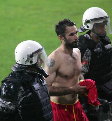 26.03.2013 Podgorica(Montenegro) Montenegro-England FIFA world cup Brazil qualifiers men football Mirko Vucinic(c) Montenegro passing through police :