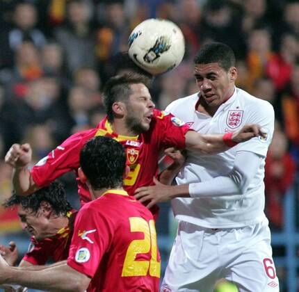 26.03.2013 Podgorica(Montenegro) Montenegro-England FIFA world cup Brazil qualifiers men football Vladimir Bozovic(c) Montenegro and Chris Smalling(r) England :