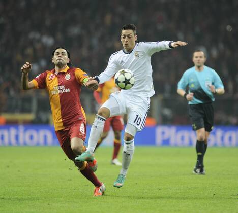 UEFA Champions League Quarter Final second leg match between Galatasaray and Real Madrid at Turk Telekom Arena Stadium on April 9, 2013 in Istanbul, Turkey. Match Scored: Galatasaray 3 - Real Madrid 2 Pictured: Mesut Ozil (R) of Real Madrid and Selcuk Inan of Galatasaray.