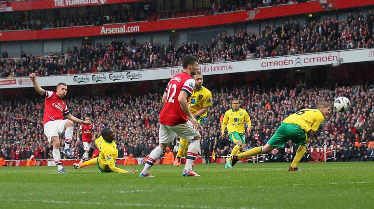 Arsenal s Lukas Podolski scoring his sides third goal.. FC Arsenal London vs Norwich City - Barclays Premier League - Emirates Stadium, London- 12 04 13 - EDITORIAL USE ONLY. No use with unauthorised audio, video, data, fixture lists, club league logos or live services. Online in-match use limited to 120 images, no video emulation. No use in betting, games or single club league player publications.