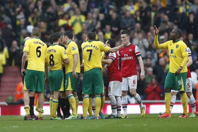 Norwich s players argue with referee Mike Jones after the award of a penalty.. FC Arsenal London vs Norwich City - Barclays Premier League - Emirates Stadium, London- 12 04 13 - EDITORIAL USE ONLY. No use with unauthorised audio, video, data, fixture lists, club league logos or live services. Online in-match use limited to 120 images, no video emulation. No use in betting, games or single club league player publications.