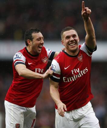 LONDON, April 13, 2013 - Lukas Podolski (R) of Arsenal celebrates scoring with his teammate Santi Cazorla during the Barclays Premier League match between Arsenal and Norwich City at the Emirates Stadium in London, Britain, on April 13, 2013. Arsenal won 3-1. (Xinhua Wang Lili)