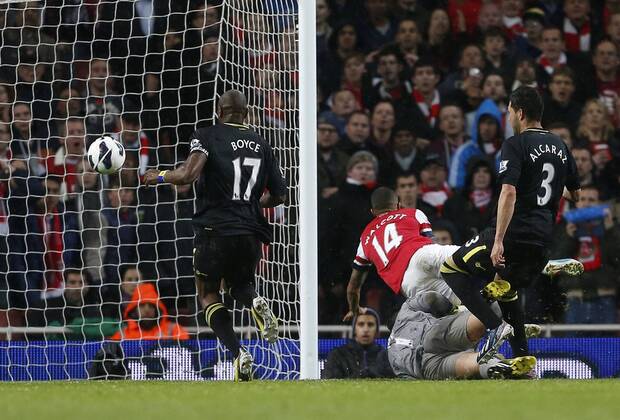 Arsenal s Theo Walcott scoring his sides second goal - Barclays Premier League - Arsenal vs Wigan - Emirates Stadium - London - 14 05 2013 - Pic David Klein Sportimage EDITORIAL USE ONLY. No use with unauthorised audio, video, data, fixture lists, club league logos or live services. Online in-match use limited to 120 images, no video emulation. No use in betting, games or single club league player publications.