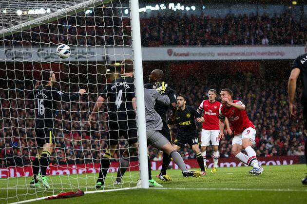 Football - 2012 2013 Premier League - Arsenal vs Wigan Lukas Podolski of Arsenal scoring his team s 1st goal at the Emirates Stadium, London