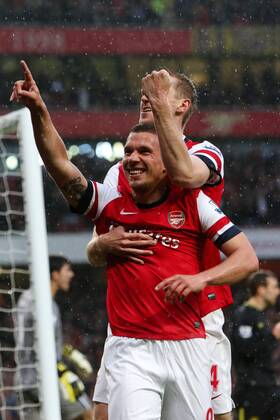 Football - 2012 2013 Premier League - Arsenal vs Wigan Lukas Podolski of Arsenal celebrates scoring his team s 1st goal at the Emirates Stadium, London