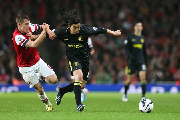 Football - 2012 2013 Premier League - Arsenal vs Wigan Wigan s Roger Espinoza and Aaron Ramsey of Arsenal at the Emirates Stadium, London