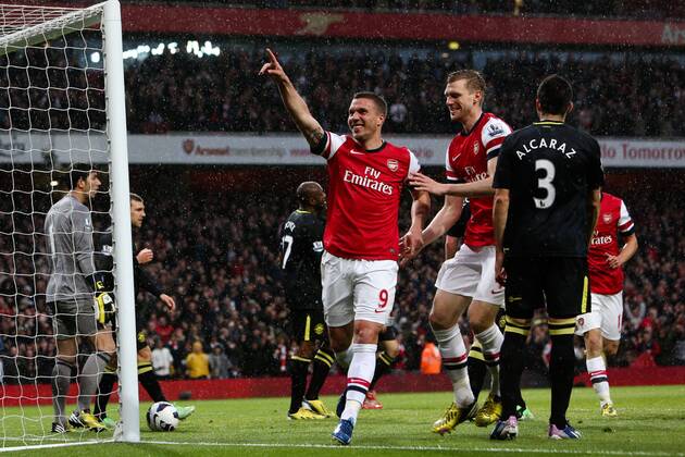 Football - 2012 2013 Premier League - Arsenal vs Wigan Lukas Podolski of Arsenal celebrates scoring his team s 1st goal at the Emirates Stadium, London