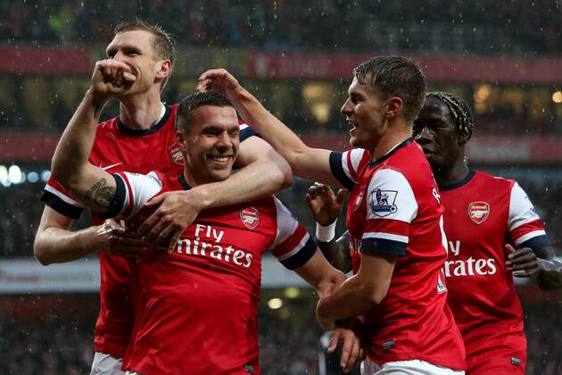 Football - 2012 2013 Premier League - Arsenal vs Wigan Lukas Podolski of Arsenal celebrates scoring his team s 1st goal at the Emirates Stadium, London