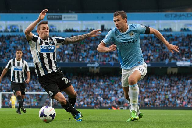 Edin Dzeko of Manchester City breaks past Hatem Ben Arfa of Newcastle United - Manchester City vs. Newcastle United - Premier League - Etihad Stadium - Manchester - 19 08 2013 Pic Philip Oldham Sportimage EDITORIAL USE ONLY. No use with unauthorised audio, video, data, fixture lists, club league logos or live services. Online in-match use limited to 120 images, no video emulation. No use in betting, games or single club league player publications.