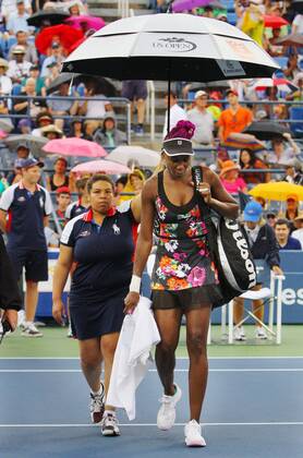 Venus Williams (USA) is escorted off the court as another rain delay suspends play at the US Open Championship at the USTA Billie Jean King National Tennis Center on August 28, 2013 in New York City. UPI Photo Monika Graff  NYP20130828318