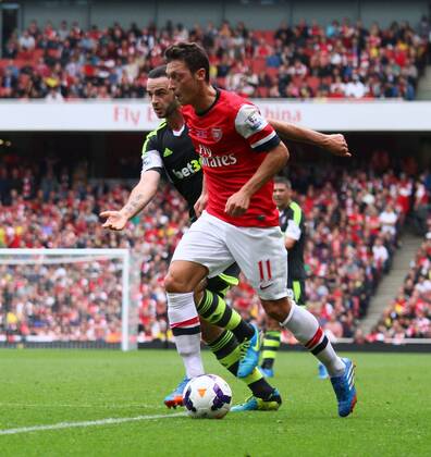 Arsenal v Stoke City . . London, UK . . 22.09.2013 Mesut Ozil (A) Marc Wilson (SC)