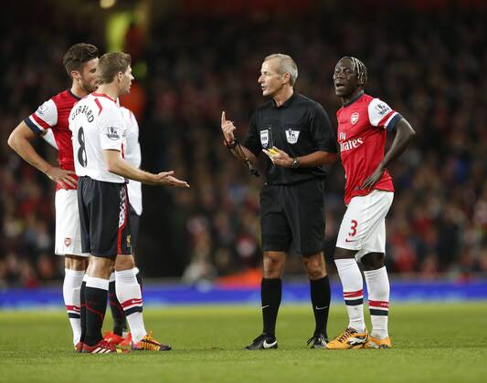 Arsenal s Bacary Sagna pleads his innocence as Liverpool s Steven Gerrard questions referee Martin Atkinson s decision not to play the advantage Arsenal v Liverpool - Barclays Premier League - Emirates Stadium - London - England -02 11 2013 - Pic David Klein Sportimage EDITORIAL USE ONLY. No use with unauthorised audio, video, data, fixture lists, club league logos or live services. Online in-match use limited to 120 images, no video emulation. No use in betting, games or single club league player publications.