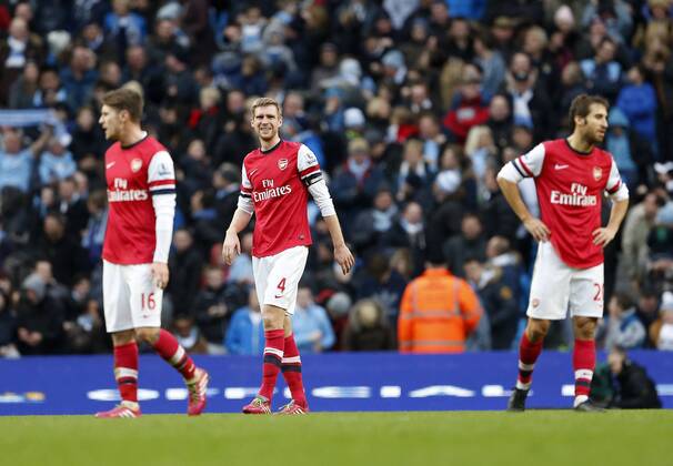 Arsenal s Per Mertesacker looks on dejected after going 3-1 down Manchester City vs Arsenal - Premier League - Etihad Stadium - Manchester - England - 14 12 2013 - EDITORIAL USE ONLY. No use with unauthorised audio, video, data, fixture lists, club league logos or live services. Online in-match use limited to 120 images, no video emulation. No use in betting, games or single club league player publications.