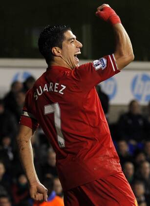 Luis Suarez of Liverpool celebrates scoring their fourth goal during the Barclays Premier League match between Tottenham Hotspur and Liverpool at White Hart Lane in London, Britain on Dec. 15, 2013. Liverpool won 5-0. (Xinhua Wang Lili) FOR EDITORIAL USE ONLY. NOT FOR SALE FOR MARKETING OR ADVERTISING CAMPAIGNS. NO USE WITH UNAUTHORIZED AUDIO, VIDEO, DATA, FIXTURE LISTS, CLUB LEAGUE LOGOS OR LIVE SERVICES. ONLINE IN-MATCH USE LIMITED TO 45 IMAGES, NO VIDEO EMULATION. NO USE IN BETTING, GAMES OR SINGLE CLUB LEAGUE PLAYER PUBLICATIONS. (SP)BRITAIN-LONDON-SOCCER-PREMIER LEAGUE-TOTTENHAM HOTSPUR VS LIVERPOOL