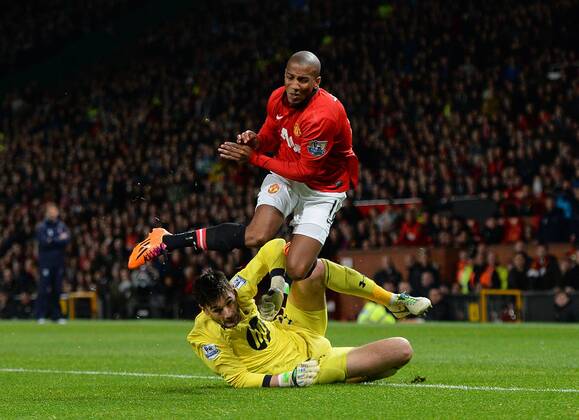 Hugo Lloris of Tottenham takes out Ashley Young of Manchester United but no penalty is given - Barclays Premier League - Manchester Utd vs Tottenham - Old Trafford Stadium - Manchester - England - 1st January 2014 - Picture Simon Bellis Sportimage EDITORIAL USE ONLY. No use with unauthorised audio, video, data, fixture lists, club league logos or live services. Online in-match use limited to 120 images, no video emulation. No use in betting, games or single club league player publications.