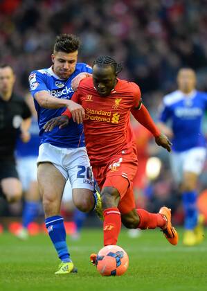 Mike Petrasso of Oldham Athletic challenges Victor Moses of Liverpool - The FA Cup with Budweiser 3rd Round - Liverpool FC vs Oldham Athletic - Anfield Stadium - Liverpool - England - 5th January 2014 - Picture SimonxBellis Sportimage EDITORIAL USE ONLY. No use with unauthorised audio, video, data, fixture lists, club league logos or live services. Online in-match use limited to 120 images, no video emulation. No use in betting, games or single club league player publications.