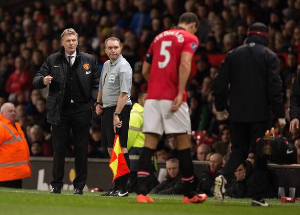 David Moyes, manager of Manchester United watches on as Rio Ferdinand of Manchester United limps off injured - Manchester United (ManU) vs. Swansea City - FA Cup Third Round - Old Trafford - Manchester - 05 01 2014 EDITORIAL USE ONLY. No use with unauthorised audio, video, data, fixture lists, club league logos or live services. Online in-match use limited to 120 images, no video emulation. No use in betting, games or single club league player publications.